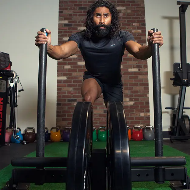 A man is working out on a machine in a gym.