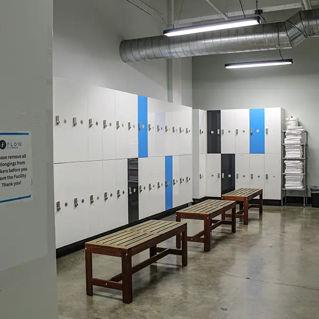 A gym with a row of lockers and benches.