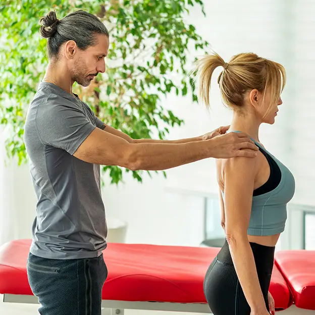 A man massaging a woman's back.