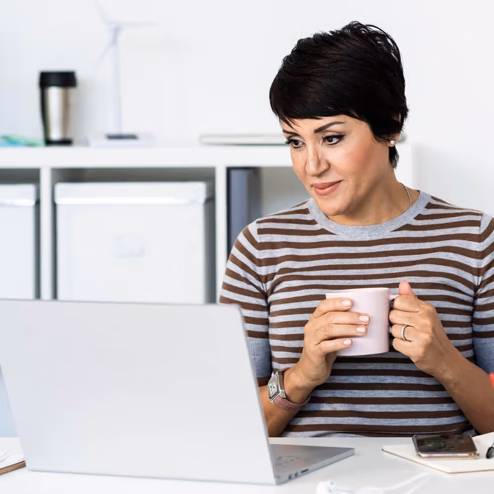 Person reviewing financial information on a laptop at home.
