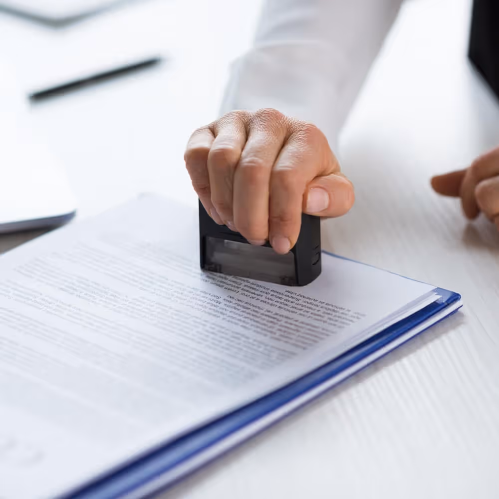 Close-up of a business document being stamped for approval.