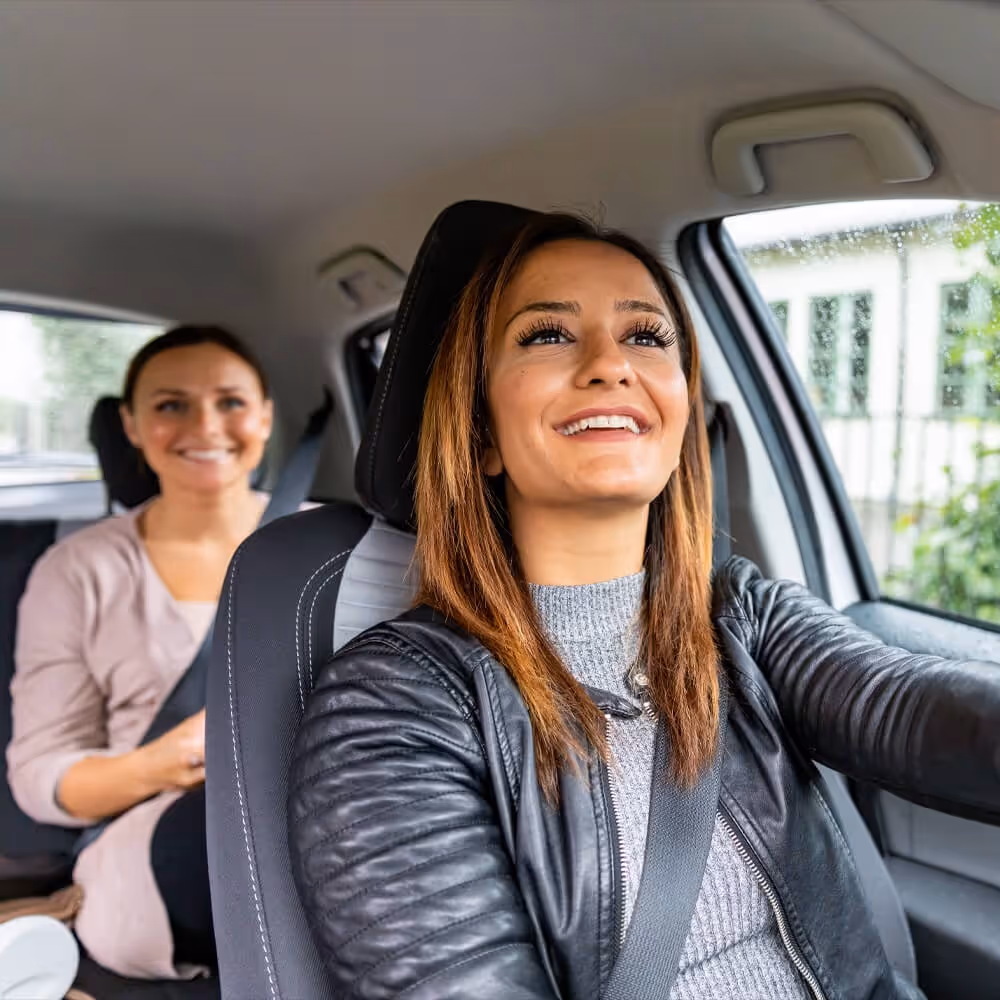 Driver transporting a passenger in a vehicle, representing rideshare services and transportation-related legal matters.