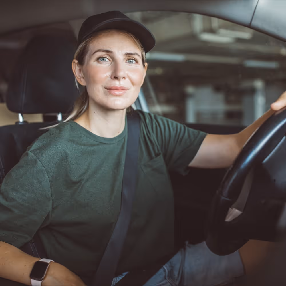 Rideshare driver seated behind the wheel of a vehicle, representing transportation and driver-related legal matters.