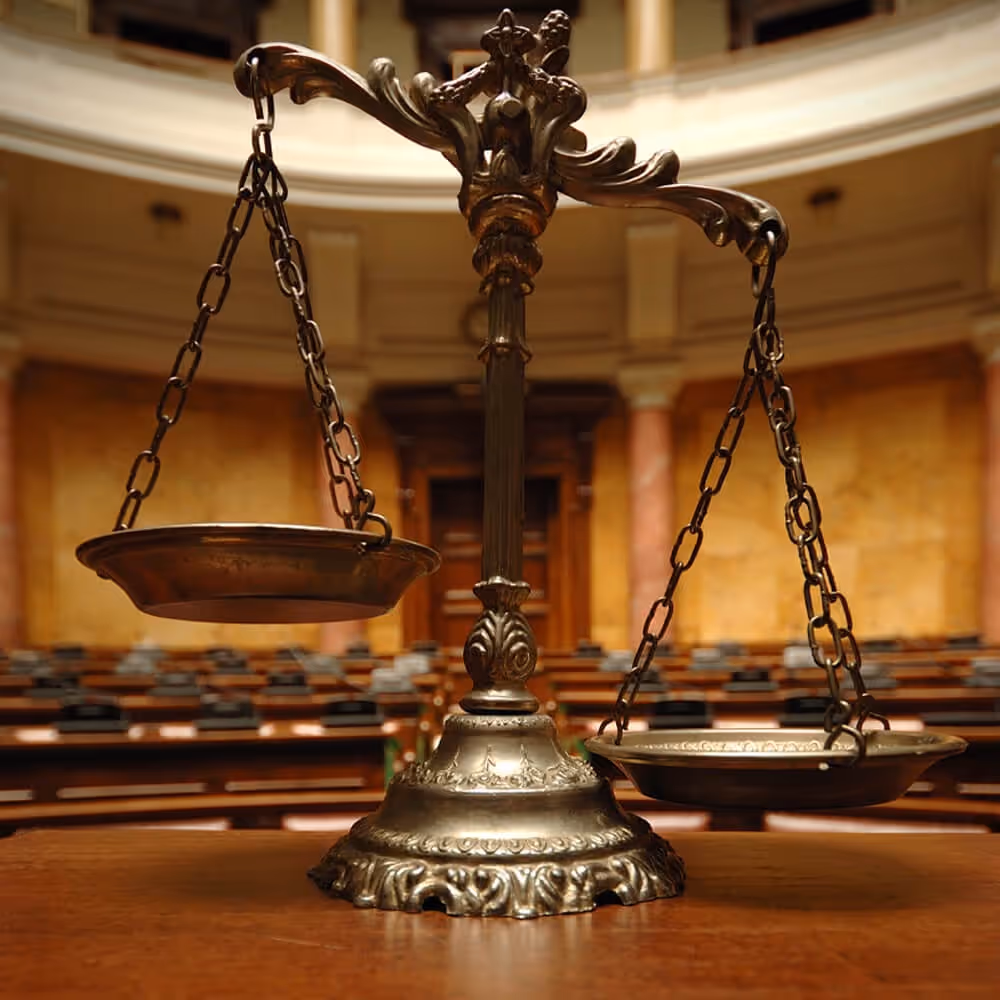 Scales of justice in a courtroom, representing business trial defense and legal proceedings.