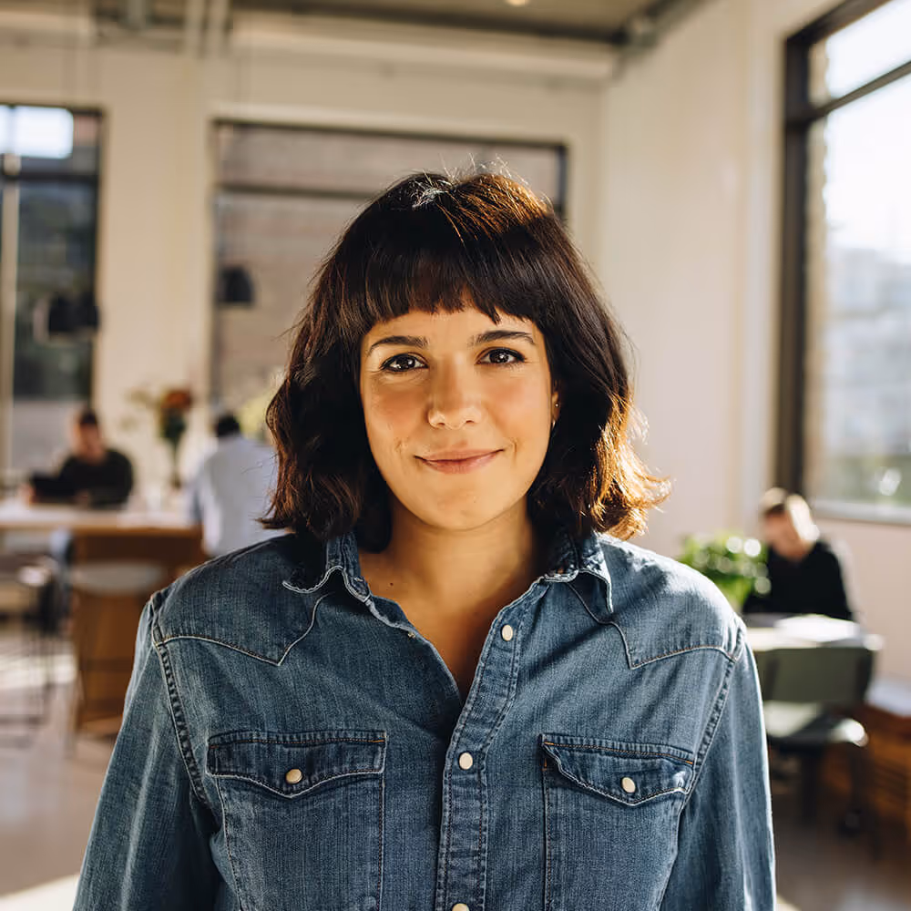 Professional standing in an office, representing employee rights and workplace legal matters.
