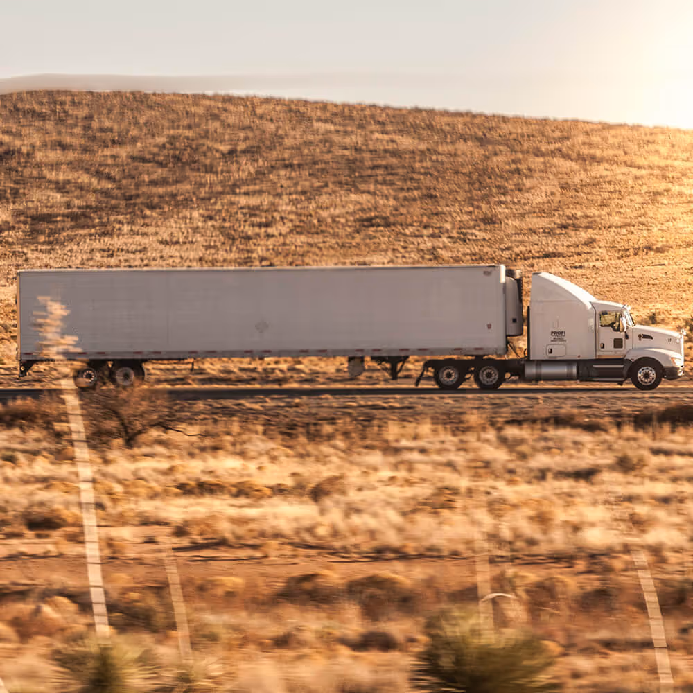 Commercial truck driving on a highway, representing legal matters related to commercial drivers and transportation.