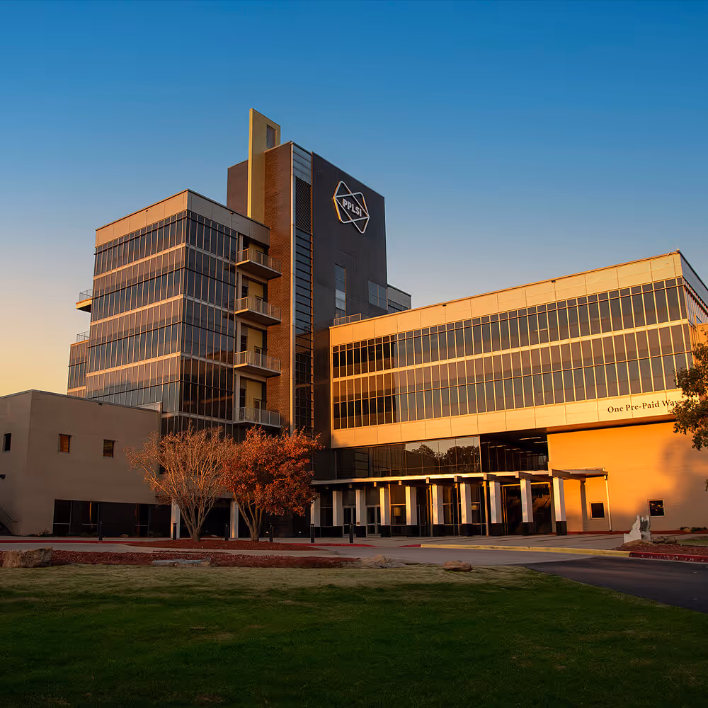 Exterior view of LegalShield’s main headquarters building in Ada, Oklahoma, at sunset.