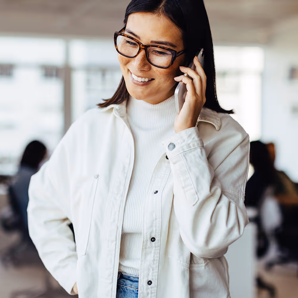 Business professional talking on the phone in an office, representing access to business legal support and guidance.