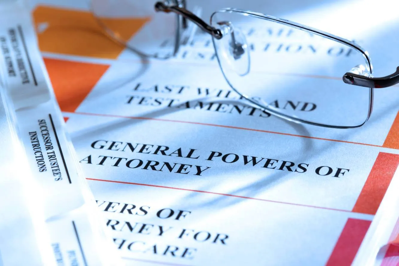 estate planning legal documents and folders along with a pay of eyeglasses