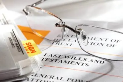 Estate planning documents and a pair of reading glasses.