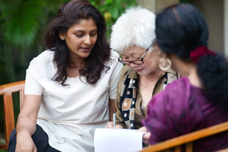 Mother talking to her 2 daughters about transfer of property after her death