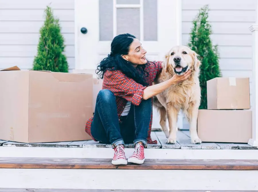Woman petting dog on porch