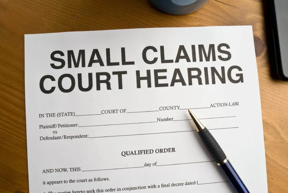 Small Claims Court Hearing Qualified Order|Small Claims Court Hearing Qualified Order|A small business owner sitting outside a Small Claim courtroom preparing for his case.|Man sitting outside a Small Claims courtroom waiting for his hearing.