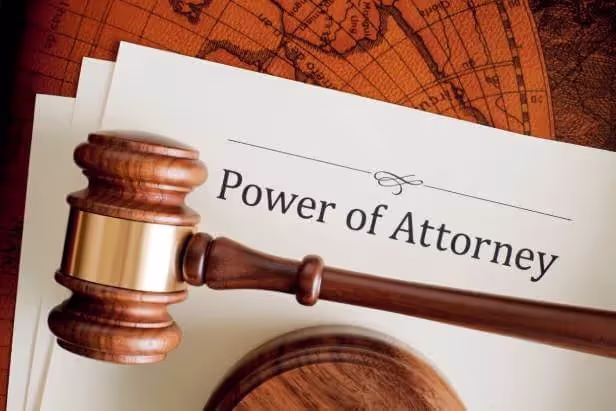 A Power of Attorney legal estate planning document on a table with a judge's gavel laying on top of it.