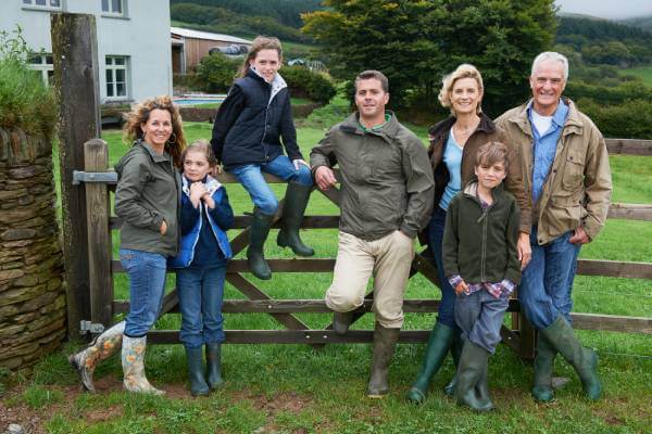 7 family member standing at a fence outside their property