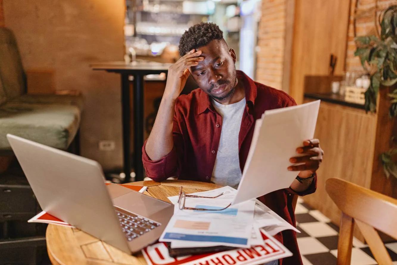 small business owner worried he might need to file for bankruptcy as he reviews business financial documents