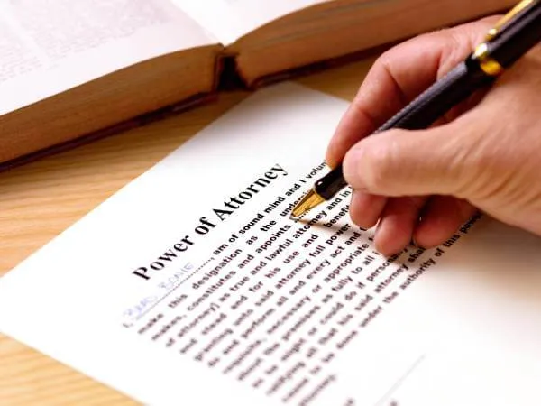 Man preparing a Power of Attorney while sitting at a desk