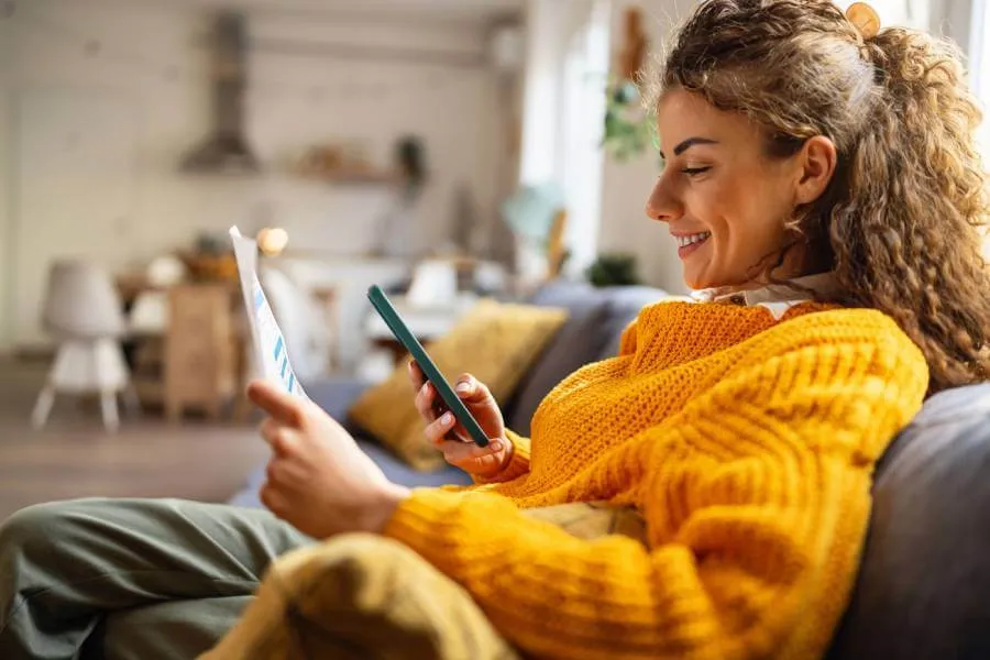 woman smiling as she gets gets help on phone with consumer law issue