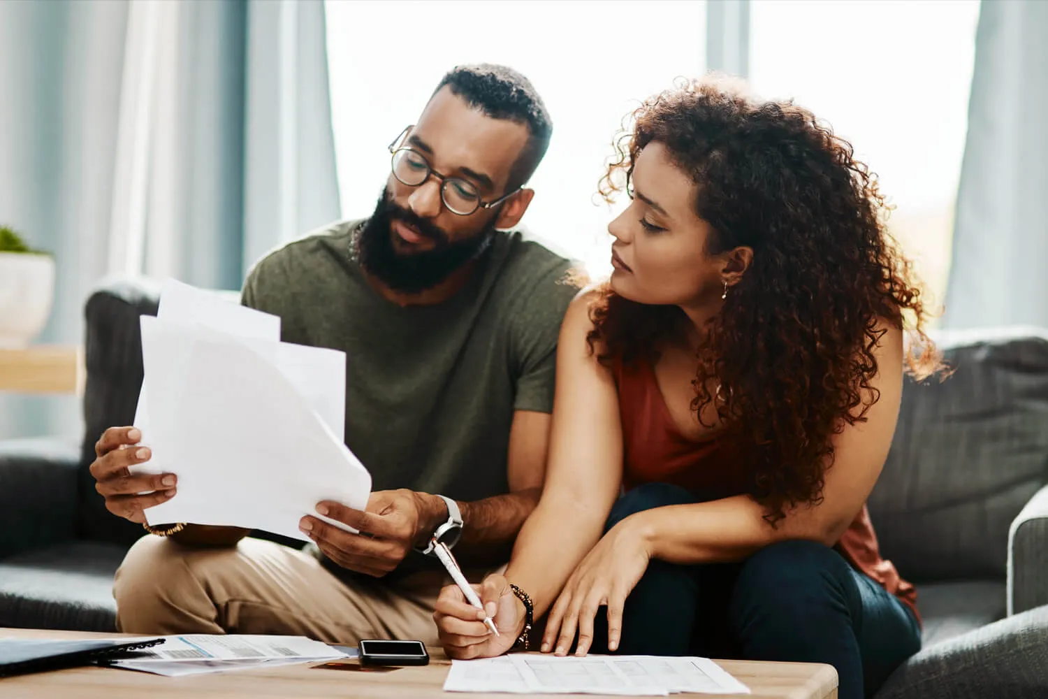 A new married couple looks through paperwork together