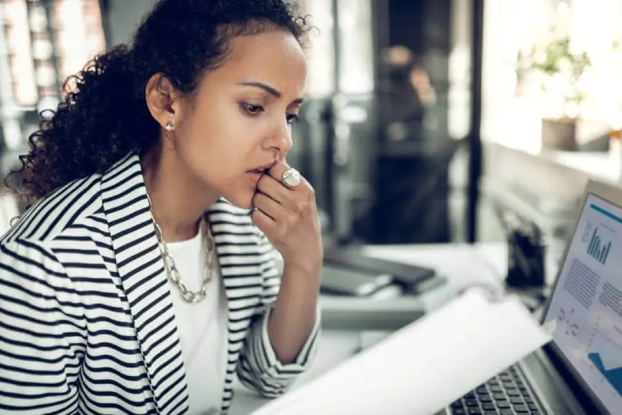 Woman reviewing a document & researching the existence of a Will