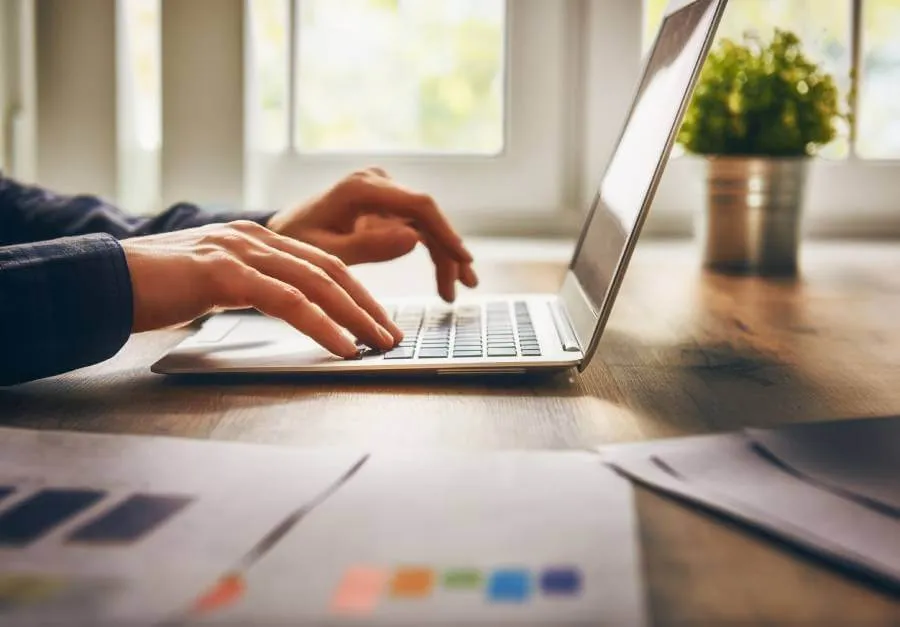 Small business owner typing on a laptop