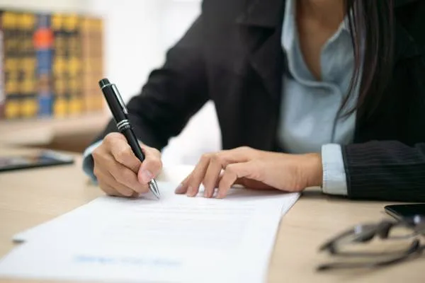Small business owner signing business formation legal document