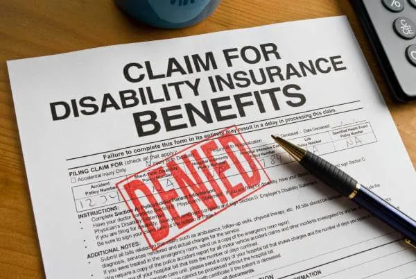 disability claim form stamped denied in red