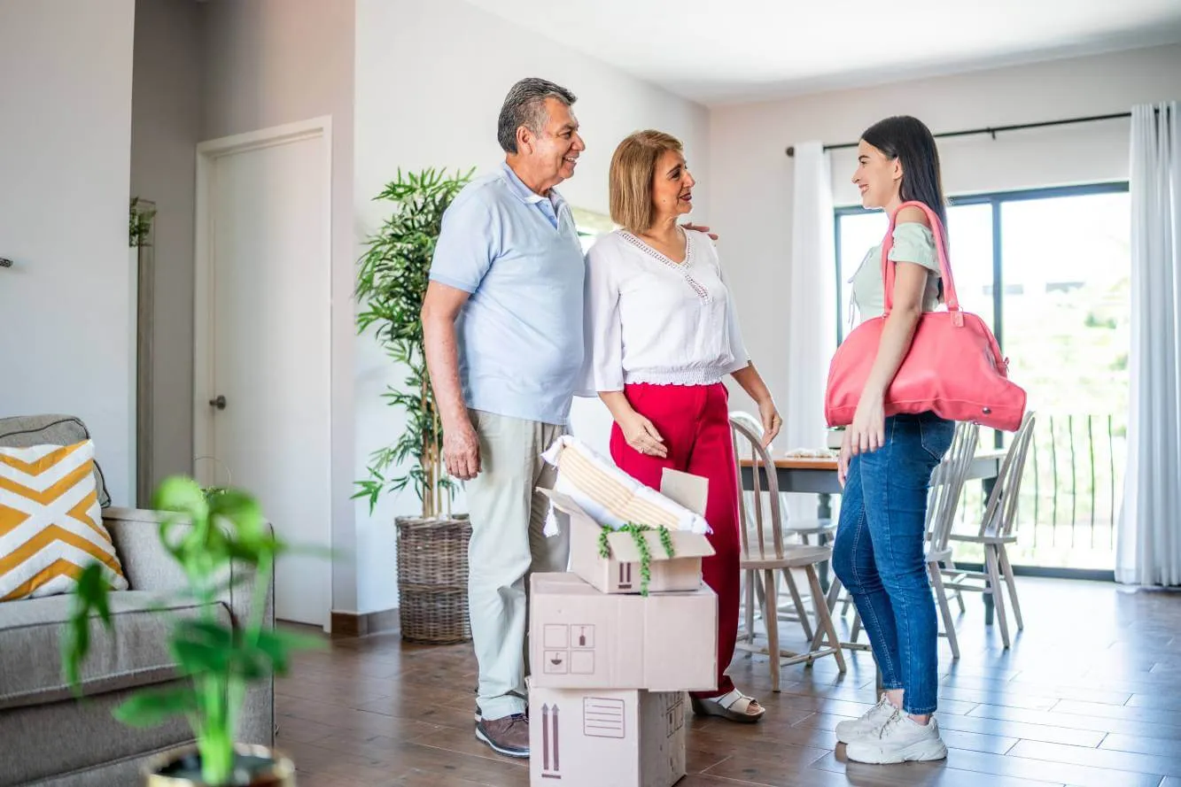 parents talking to adult daughter as she moves into apartment with lease cosigned by parents