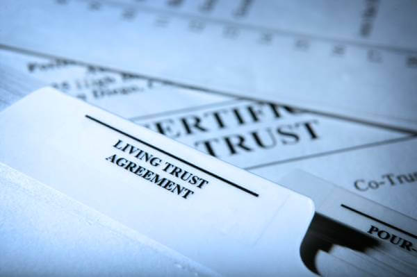 Trust legal documents including a folder labeled Living Trust Agreement