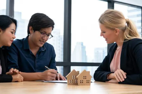 man signing a home purchase agreement