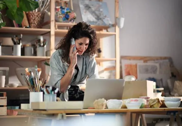 Small business owner talking to lawyer on her phone
