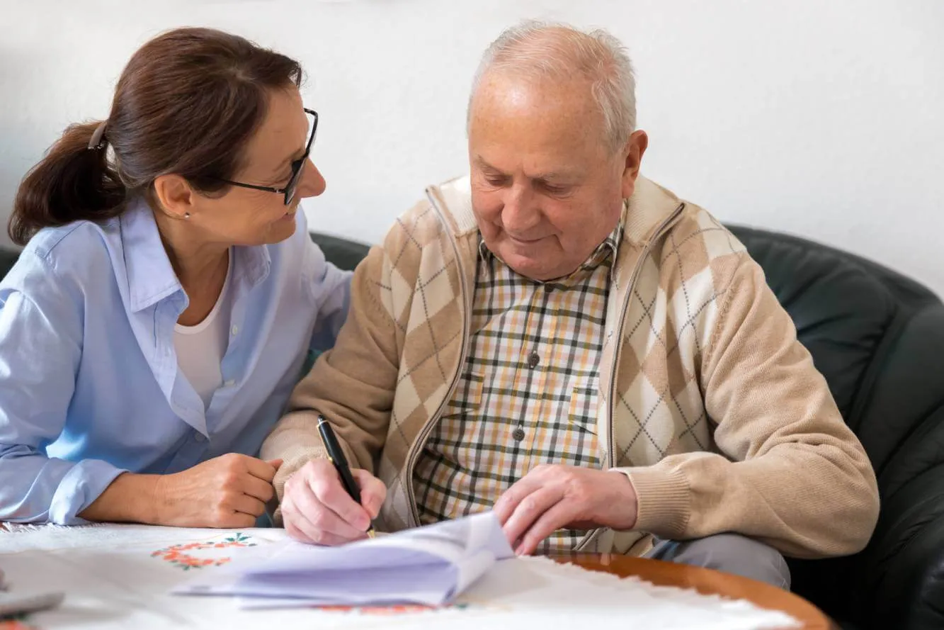 elderly man designating his beneficiaries on an insurance policy