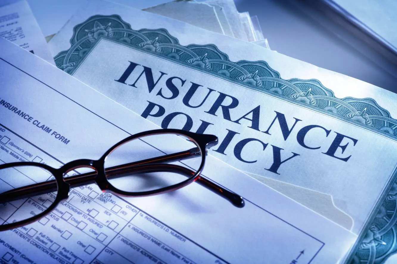 insurance policy, insurance claim form and eyeglasses