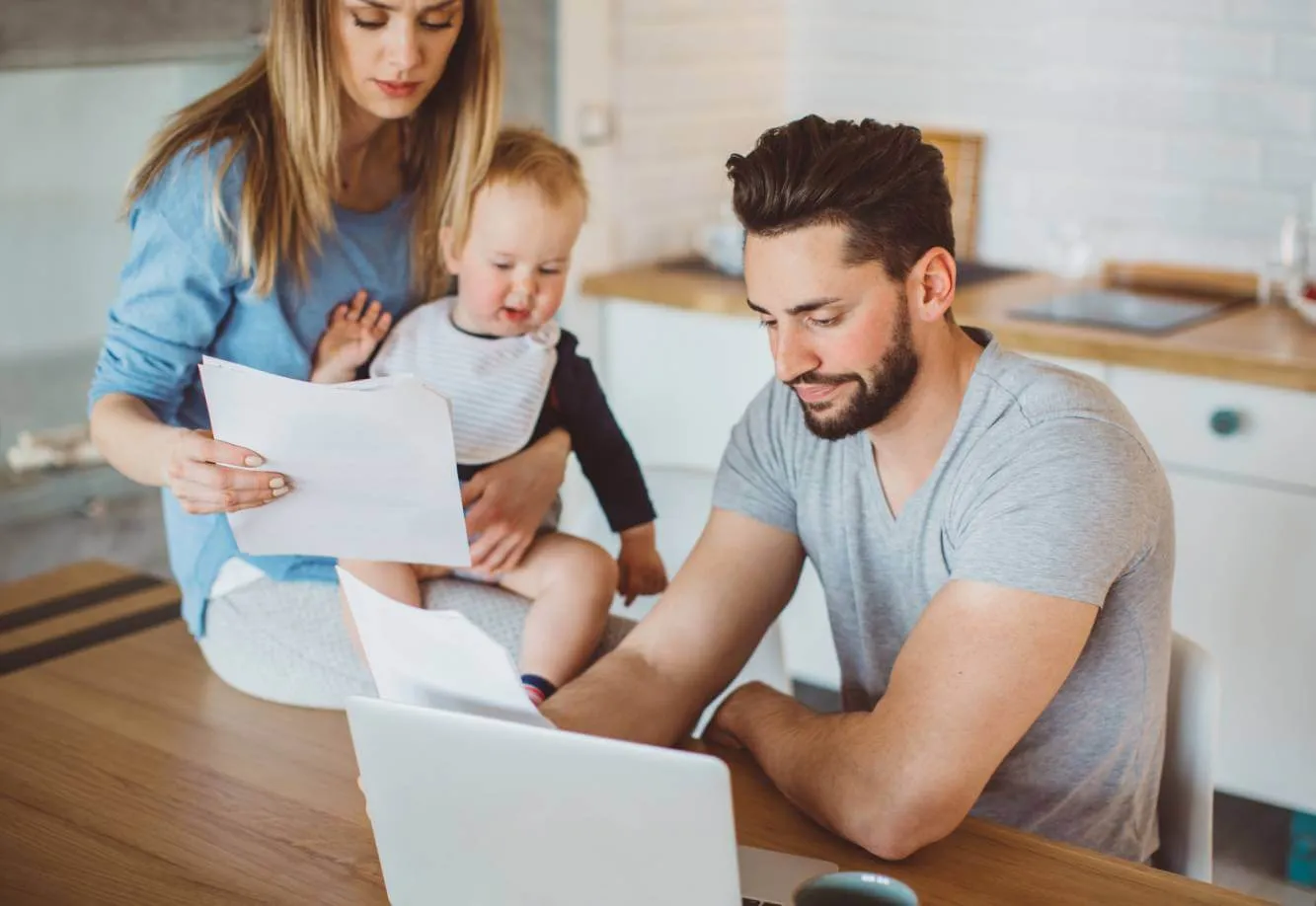 Young father, mother and child looking at a laptop to create their Will with LegalShield membership