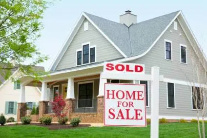 Home with Sold Home for Sale sign in front yard.