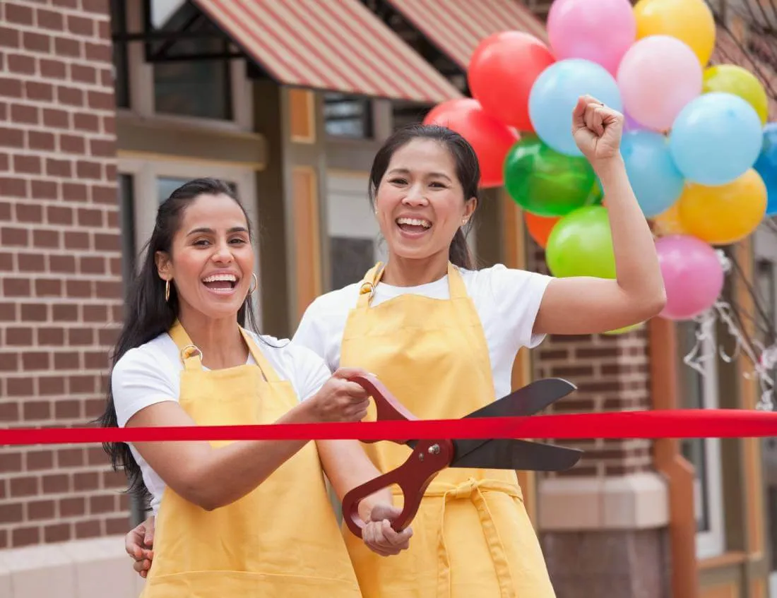 small business owner doing an opening ribbon-cutting for her new small business she has registered