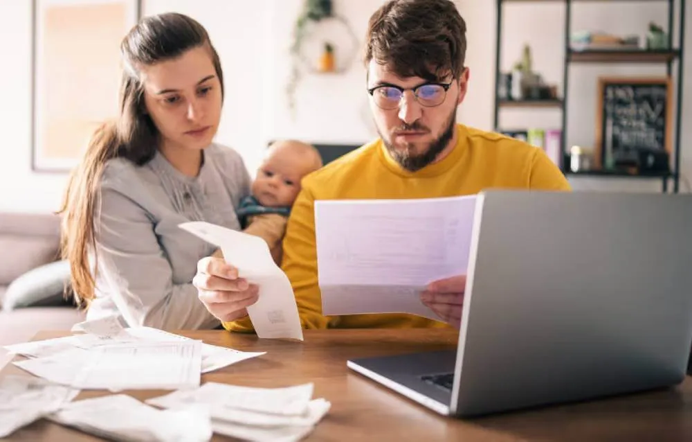 New parents with a small baby reviewing their need to file a tax extension