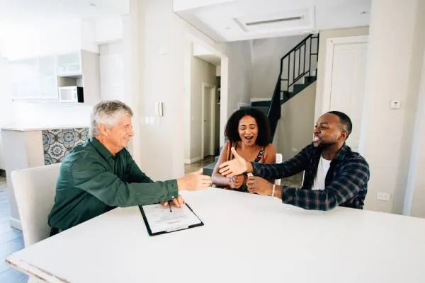home seller shaking hands with a home buyer 