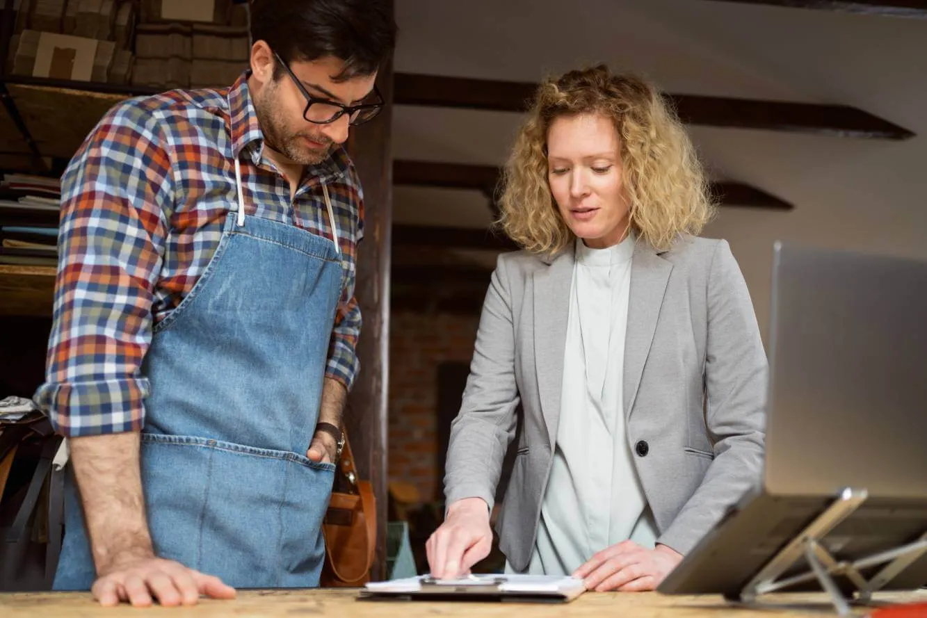 lawyer advising business owner in his shop on dba vs llc