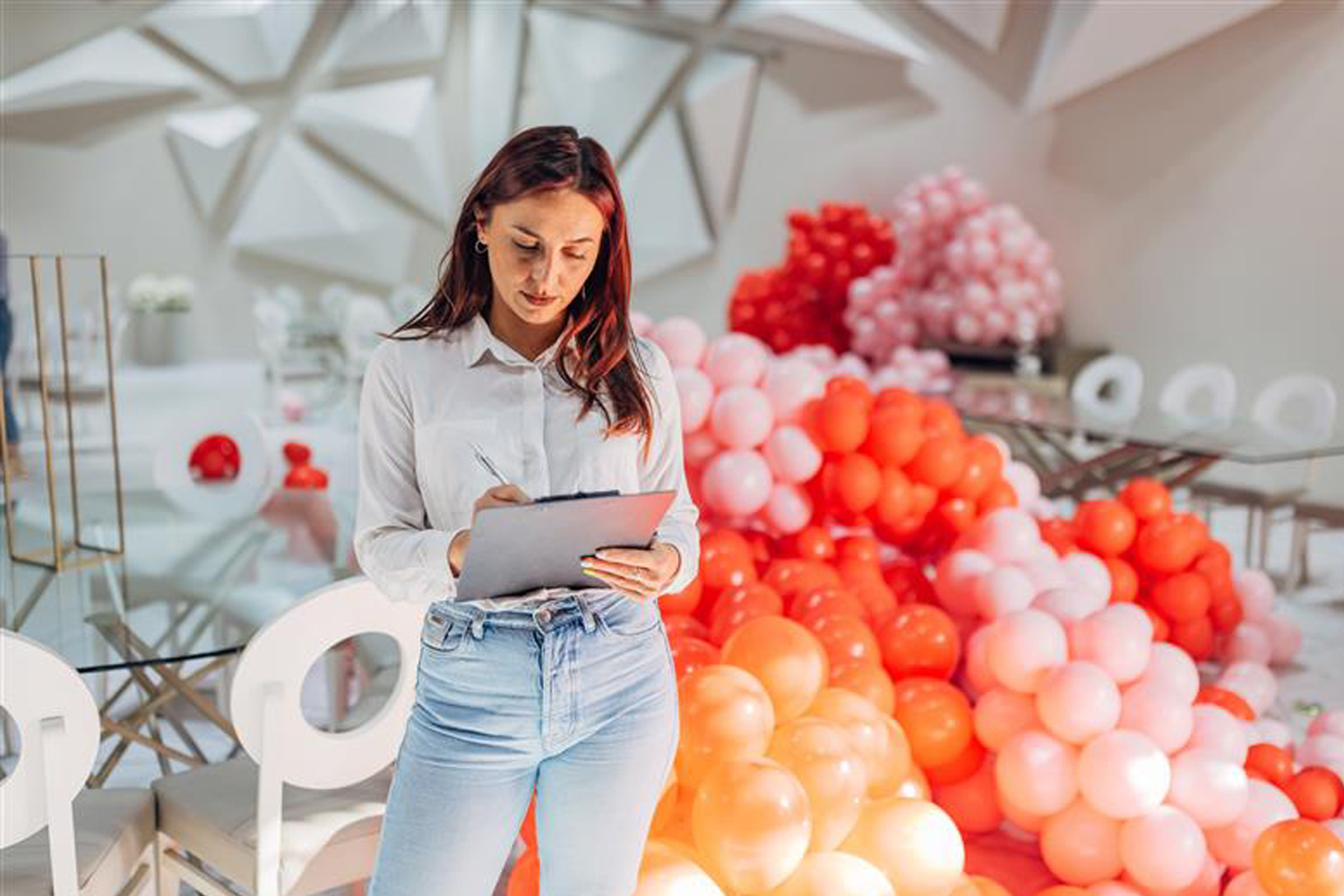 A female party organizer crosses tasks off her to-do list