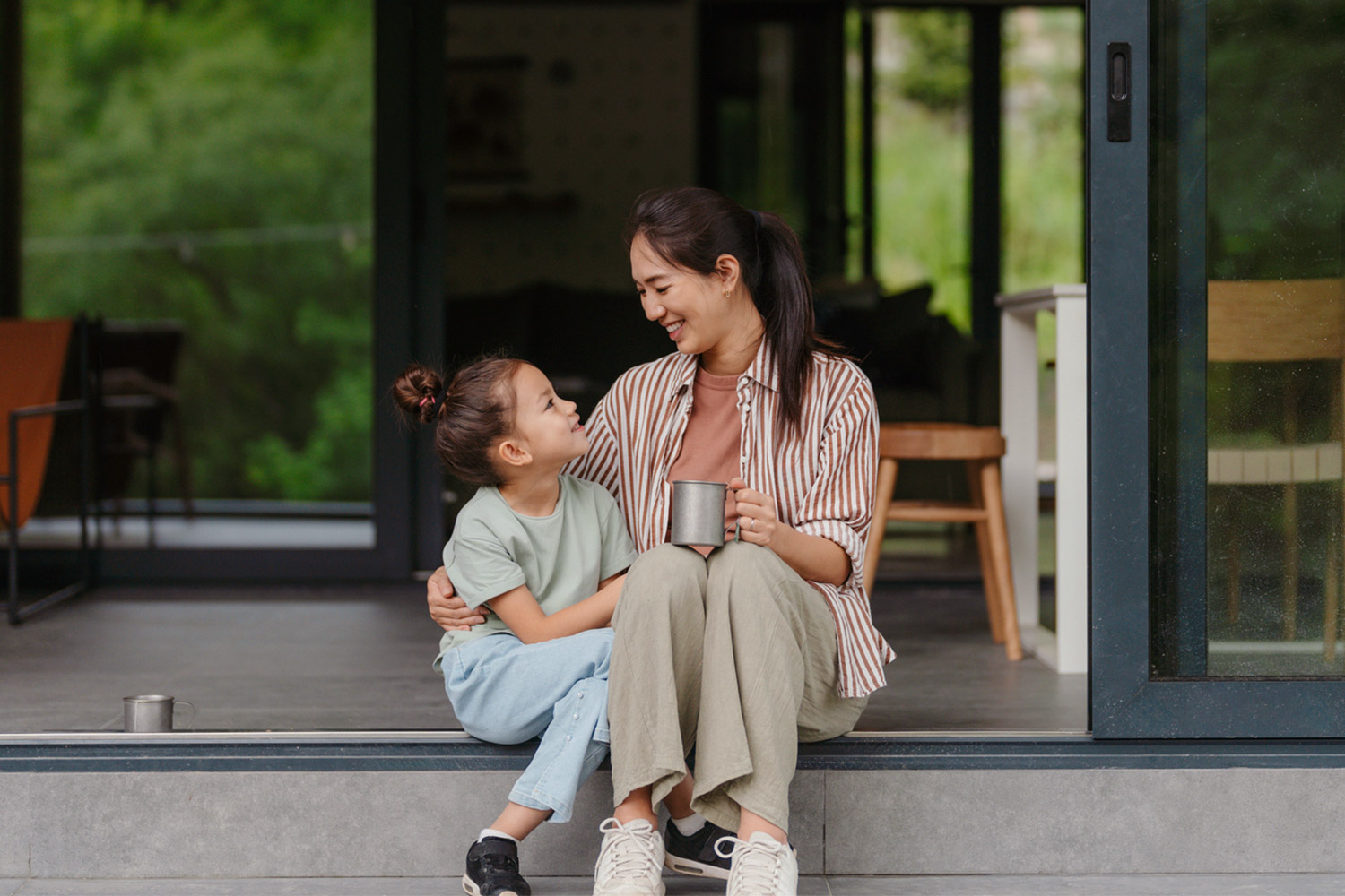 A mother and daughter sit on their front step, talking about when probate is required.