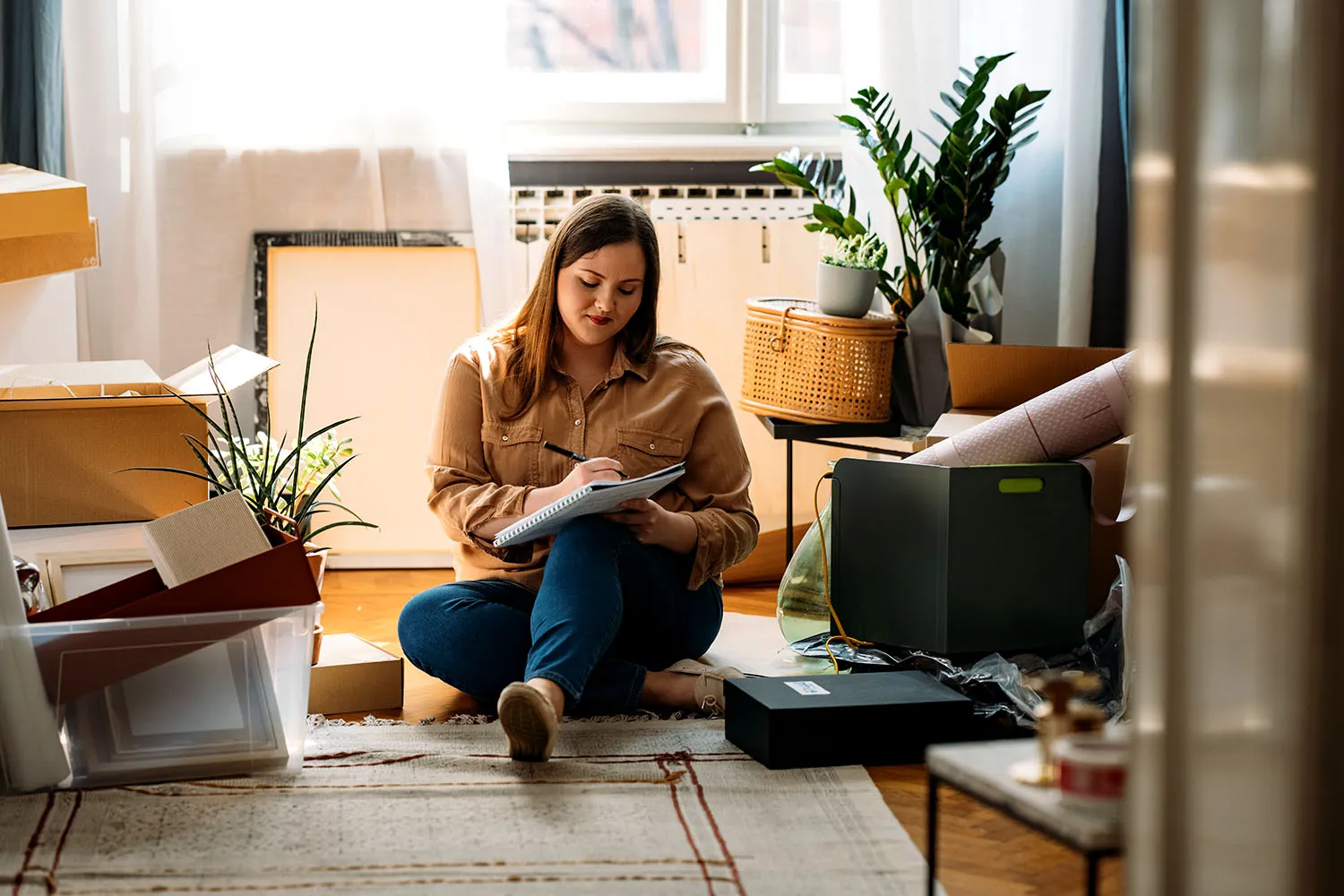 A woman sitting in her living room planning to use a quitclaim deed.
