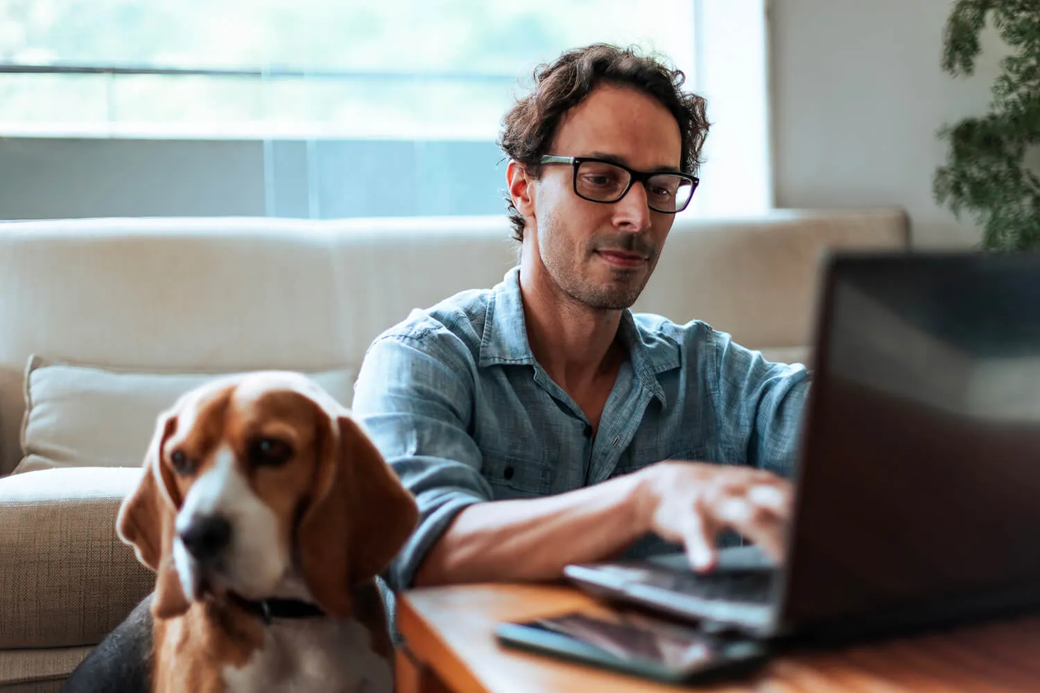 A man works on a laptop