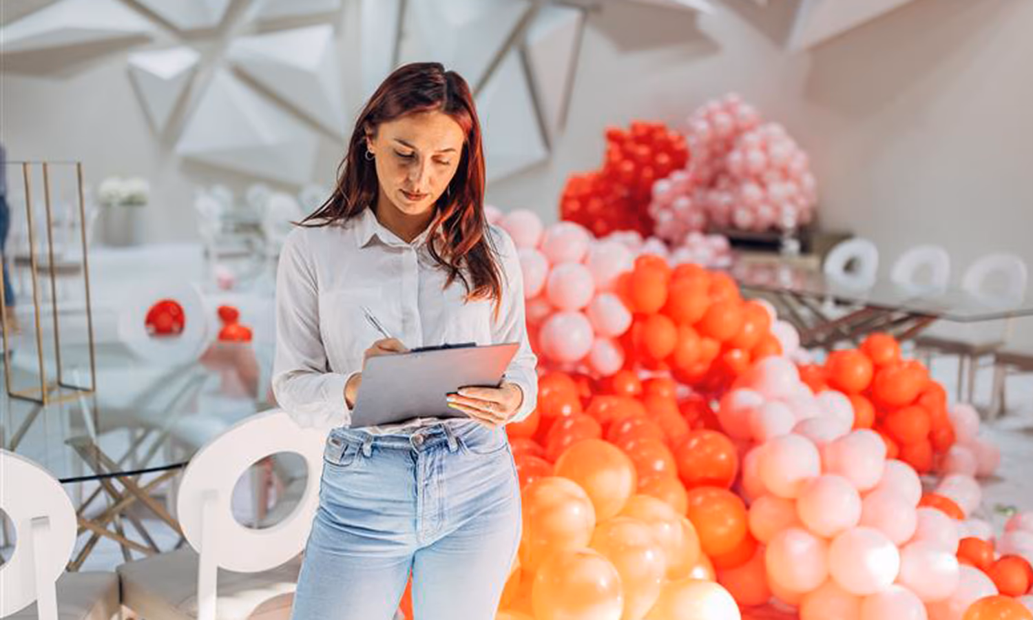 A female party organizer crosses tasks off her to-do list