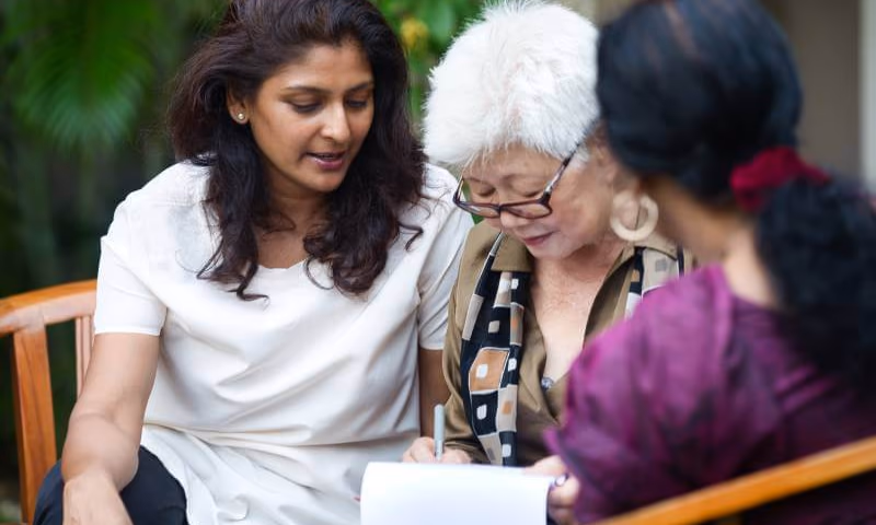 Mother talking to her 2 daughters about transfer of property after her death