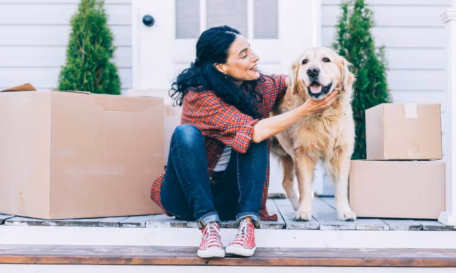 Woman petting dog on porch