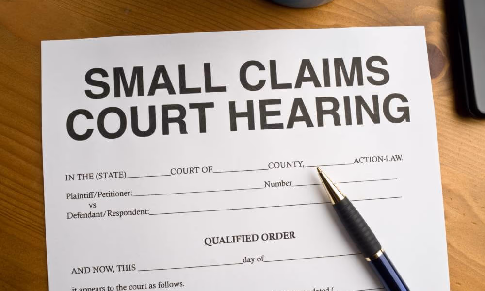 Small Claims Court Hearing Qualified Order|Small Claims Court Hearing Qualified Order|A small business owner sitting outside a Small Claim courtroom preparing for his case.|Man sitting outside a Small Claims courtroom waiting for his hearing.