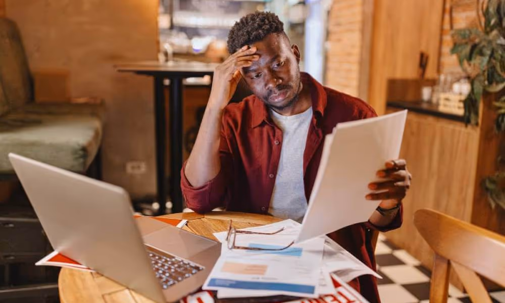 A small business owner stressed while filing his business taxes