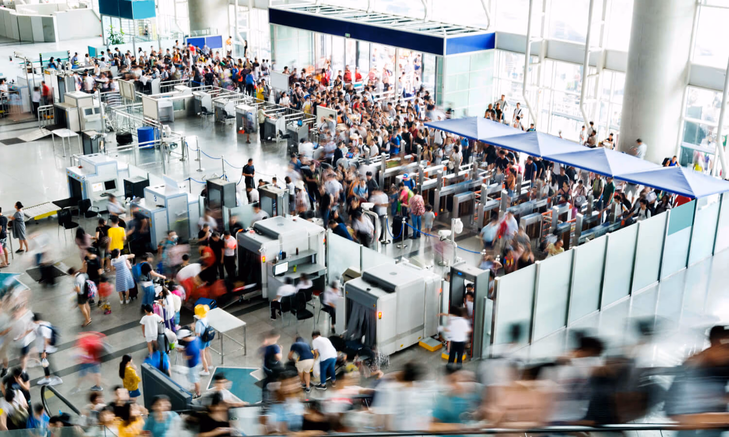 A crowd of people wait in the security line