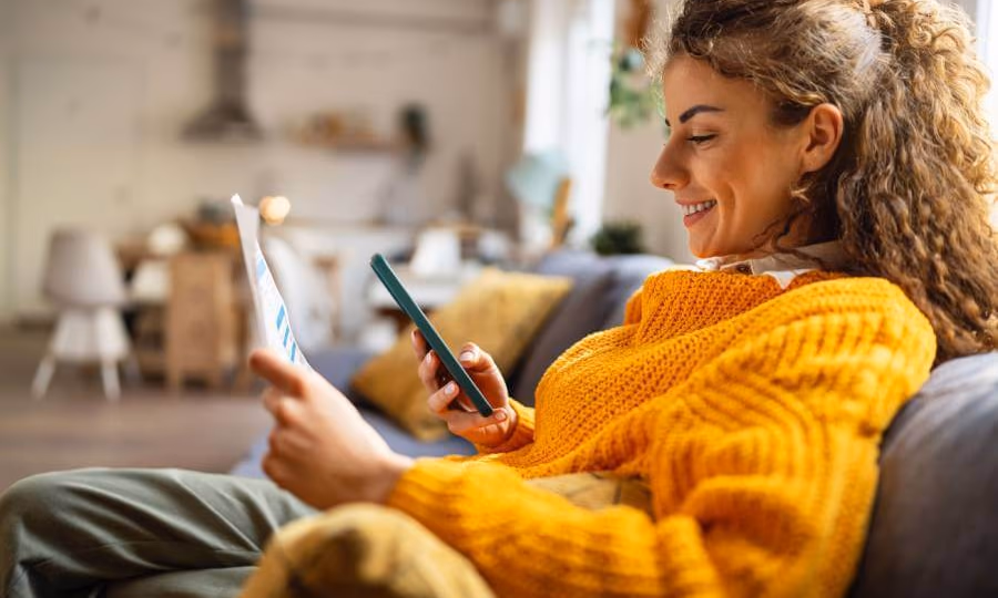 woman smiling as she gets gets help on phone with consumer law issue